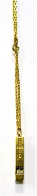 Lot 296 - A 9ct gold diamond and sapphire set ingot pendant on chain