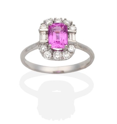 Lot 329 - An 18 Carat White Gold Pink Sapphire and Diamond Cluster Ring, a cushion cut pink sapphire in a...