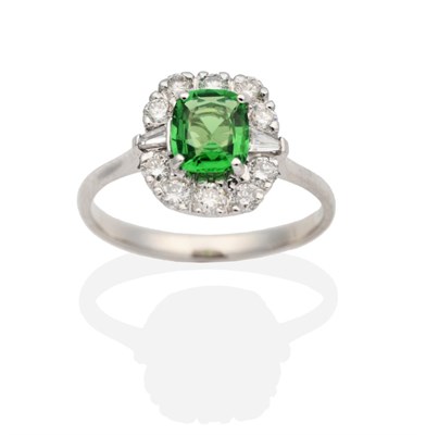 Lot 334 - An 18 Carat White Gold Green Garnet and Diamond Cluster Ring, a cushion cut green garnet in a...