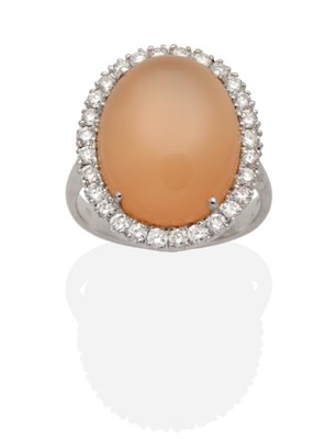 Lot 337 - An 18 Carat White Gold Moonstone and Diamond Cluster Ring, an oval cabochon peach moonstone...