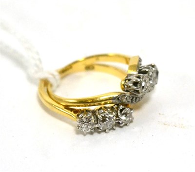 Lot 386 - A diamond three stone ring, 0.35 carat and a diamond three stone twist ring (2)