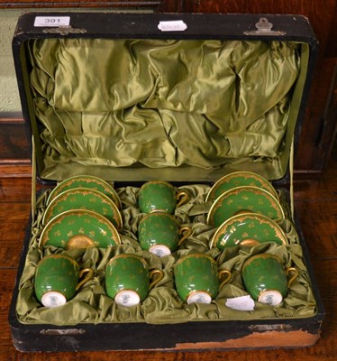 Lot 391 - A cased Coalport coffee service with gilt decoration on a green ground, pattern number 4566