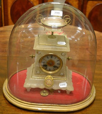 Lot 398 - A Victorian alabaster striking mantel clock, beneath a glass dome