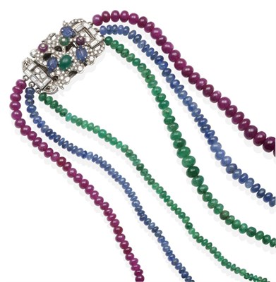 Lot 347 - An 18 Carat White Gold Multi-Gemstone Necklace, graduated strands of emerald, sapphire and ruby...