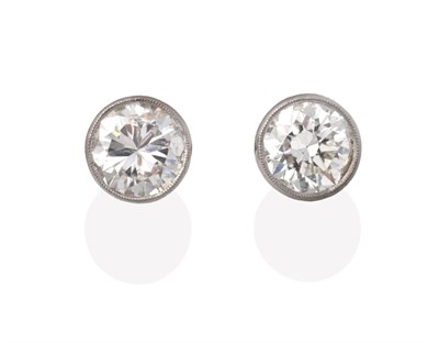 Lot 354 - A Pair of Solitaire Diamond Earrings, round brilliant cut diamonds in rubbed over setting,...