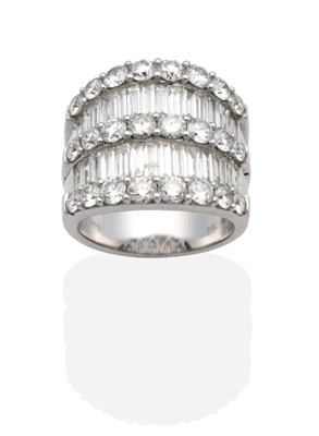 Lot 360 - A Diamond Ring, three slightly graduated bands of round brilliant cut diamonds in claw settings...