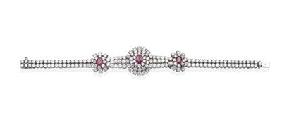 Lot 362 - A Ruby and Diamond Bracelet, an oval cut ruby in a claw setting within a three tier border of round