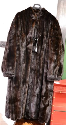 Lot 1123 - Dark mink fur coat, collarless with long sleeves and scalloped hem