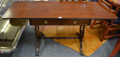 Lot 1141 - A reproduction mahogany drop leaf sofa table, labelled J Sydney Smith, fitted two frieze...