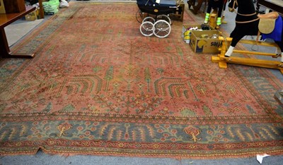 Lot 1148 - Large Ushak carpet, Central Anatolia, the salmon pink field of trees and plants enclosed by...