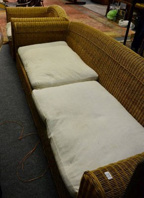 Lot 1150 - A large Rattan settee and matching armchair by Pavilion