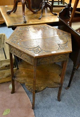 Lot 1177 - An early 20th century hexagonal carved oak two tier centre table