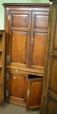 Lot 1306 - George III panelled oak standing corner cupboard