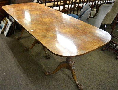 Lot 1343 - A burr walnut triple pedestal dining table raised on ball and claw feet