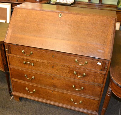 Lot 1348 - A George III oak bureau