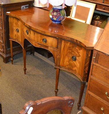 Lot 1349 - A mahogany serpentine sideboard