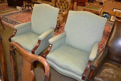 Lot 1354 - A pair of reproduction mahogany open armchairs in green cotton, with squabs