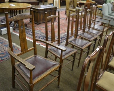 Lot 1371 - A set of six (4+2) Arts & Crafts oak dining chairs, each with a shaped top rail over a central slat