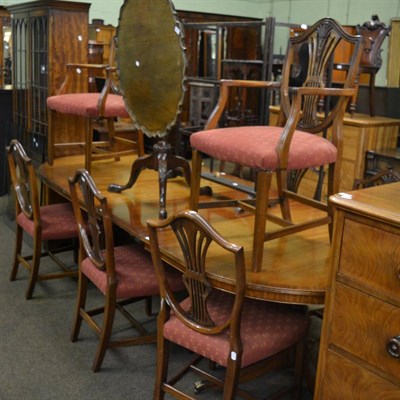 Lot 1389 - A reproduction pedestal dining table with two additional leaves, a matching sideboard and a similar