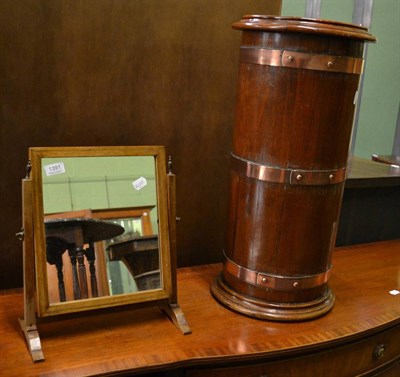 Lot 1391 - A copper bound oak stick stand, together with a small shaving mirror