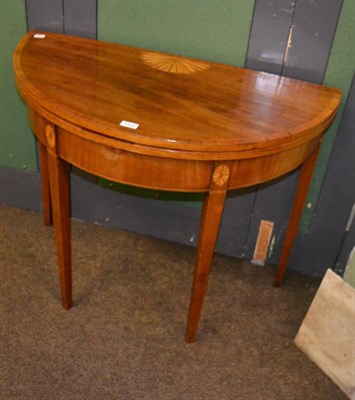 Lot 1410 - A George III inlaid mahogany demi lune fold over card table