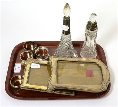 Lot 3 - Two silver mounted photograph frames, two cut glass silver mounted scent bottles and four...