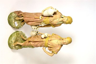 Lot 19 - A pair of Royal Dux porcelain figures of water carriers