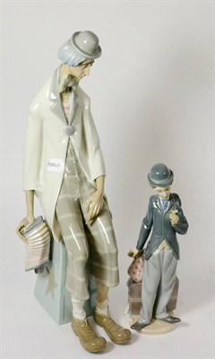 Lot 40 - Large Lladro figure of a seated tramp with accordion and another resembling Charlie Chaplin