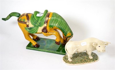 Lot 42 - A Chinese pottery horse and a ceramic figure of a bull (2)