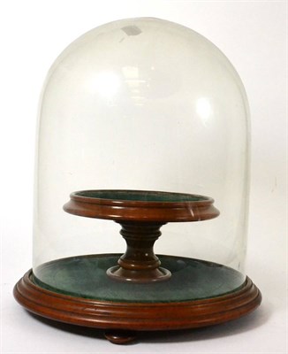 Lot 55 - A glass dome on stand with turned pedestal