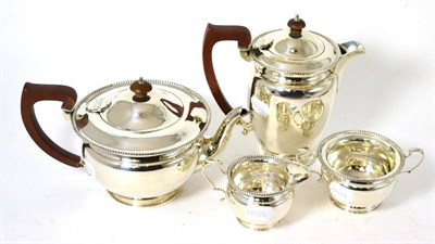Lot 63 - A silver four piece tea service, comprising teapot, hot water jug, cream jug and sugar bowl...