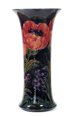 Lot 467 - William Moorcroft (1872-1945): A Big Poppy Pattern Trumpet Vase, circa 1925, on a dark blue ground