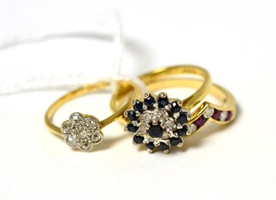Lot 91 - A ruby and diamond wishbone ring, a diamond cluster ring and a sapphire and diamond ring