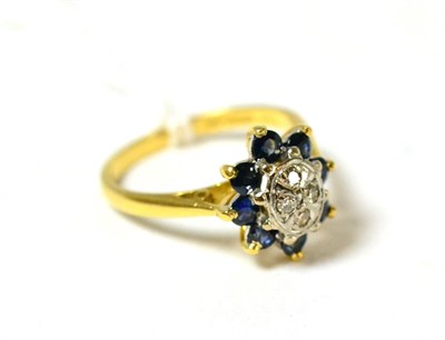 Lot 99 - An 18ct gold diamond and sapphire cluster ring