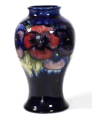 Lot 468 - William Moorcroft (1872-1945): A Pansy Pattern Vase, circa 1930, on a dark blue ground,...