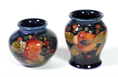 Lot 474 - William Moorcroft (1872-1945): Two Pomegranate Pattern Vases, both on blue grounds and...