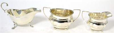 Lot 197 - A silver cream jug, sugar bowl and a sauce boat