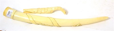 Lot 199 - An early 20th century carved ivory tusk decorated with animals, together a carved crocodile (2)