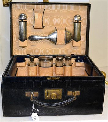 Lot 229 - A leather cased travel set, with cut glass bottles and silver mounts, the lid stamped B.D.S...