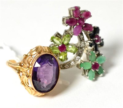 Lot 270 - A synthetic sapphire imitating alexandrite, in ornate ring mount and a multi-gemstone ring...