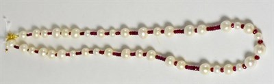 Lot 278 - A cultured pearl and ruby necklace, the cultured pearls strung with faceted rubies, length 58cm