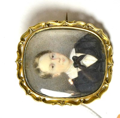 Lot 357 - An early Victorian portrait miniature on ivory, depicting a boy, bust length, wearing a dark...