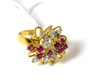 Lot 363 - An 18ct gold ruby and diamond cluster ring, of abstract floral form, set with round cut rubies...