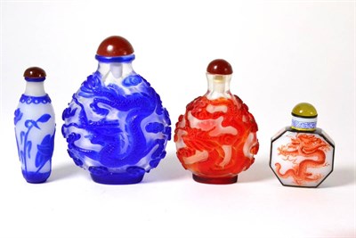 Lot 374 - Four snuff bottles and tops, (one top a.f.)