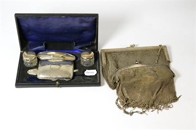 Lot 392 - A silver mounted manicure set, two mesh purses and a hammered silver cigarette case