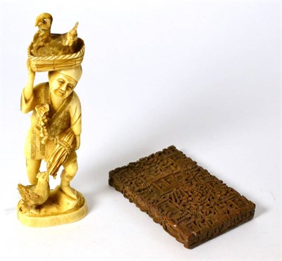 Lot 393 - Carved ivory figure of a farmer with his chickens, circa 1900, and a carved card case and cover