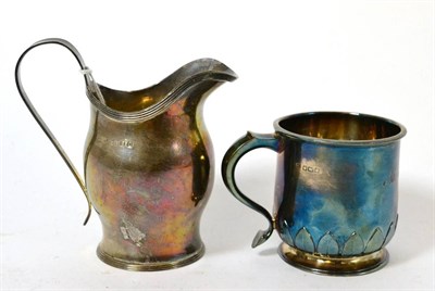 Lot 408 - A modern silver cream jug and a Christening mug (acorn marks)