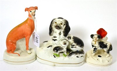 Lot 409 - Staffordshire figure of a seated red hound, a group with seated black spaniel and puppy,...