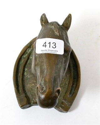 Lot 413 - A bronze model of a horse head within a horseshoe, possibly a wall mount or paperweight