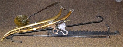 Lot 444 - A pair of brass hames, iron adjustable rekan and pot hook, cream skimmer and fire tongs